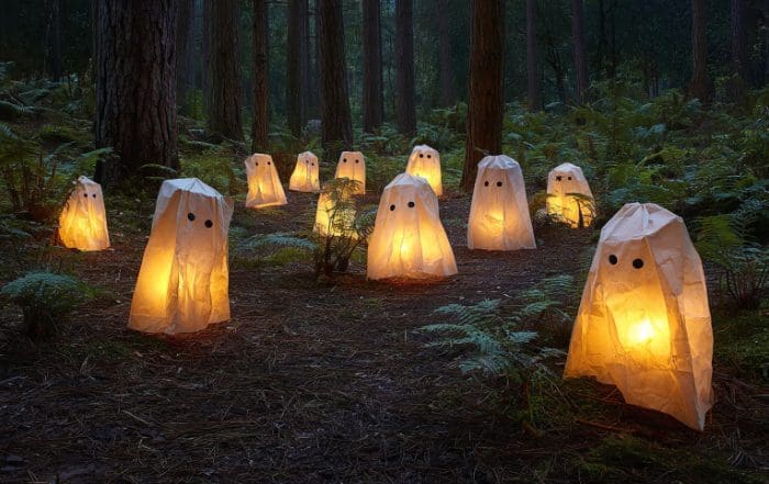 Spooky Paper Bag Ghost Lanterns in a Dark Ancient Forest at Night – Halloween Decoration Photography